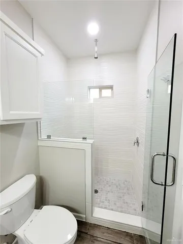 a white toilet sitting next to a bathroom sink