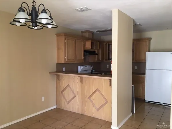 a kitchen with stainless steel appliances a refrigerator and a stove top oven