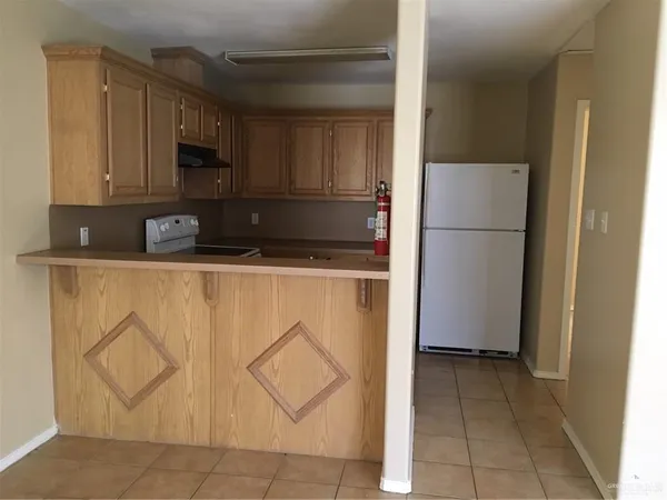 a kitchen with stainless steel appliances granite countertop a refrigerator sink and cabinets