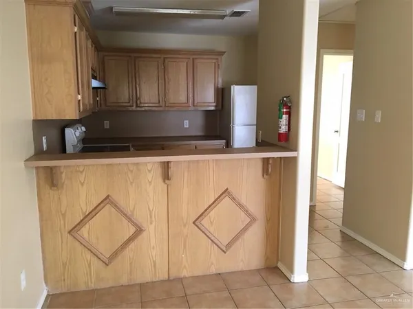a kitchen with a cabinets and a refrigerator
