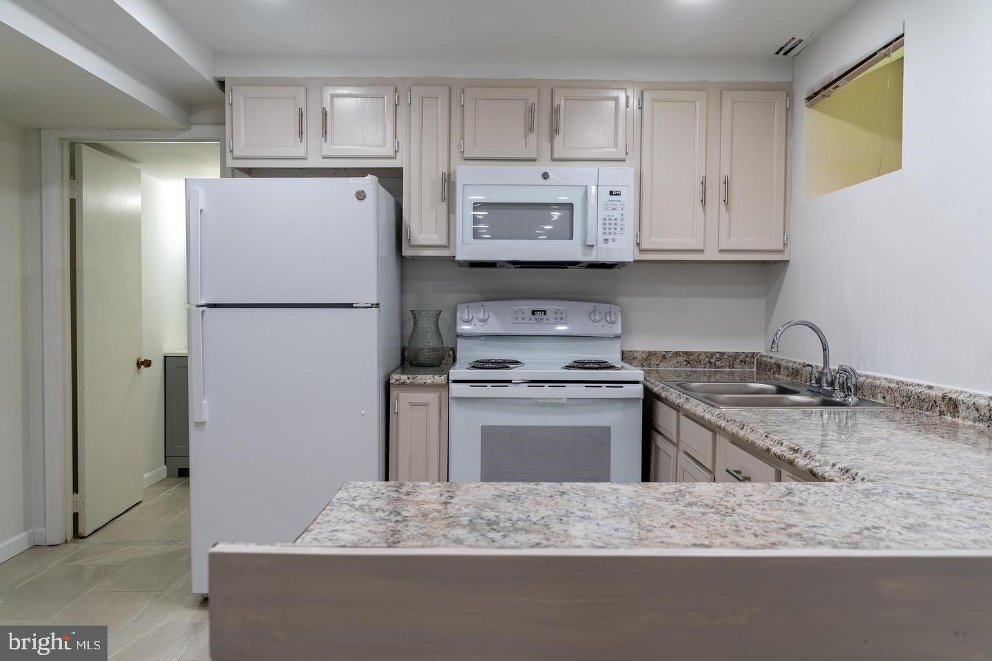 14913 Lear Lane Silver Spring, MD 20905 - Photo 29 of 33 Modern kitchen with sleek finishes.