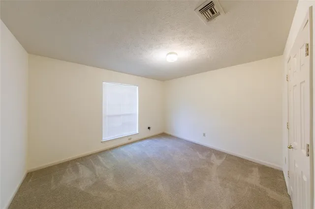 an empty room with a empty space and windows