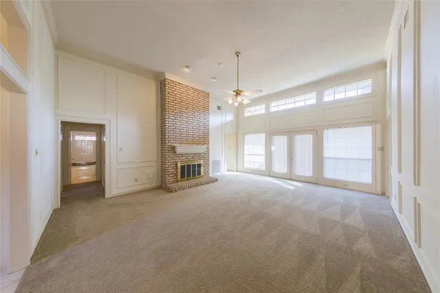 a view of empty room with a fireplace and chandelier