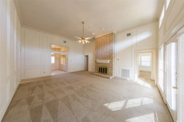 a view of an empty room with a kitchen