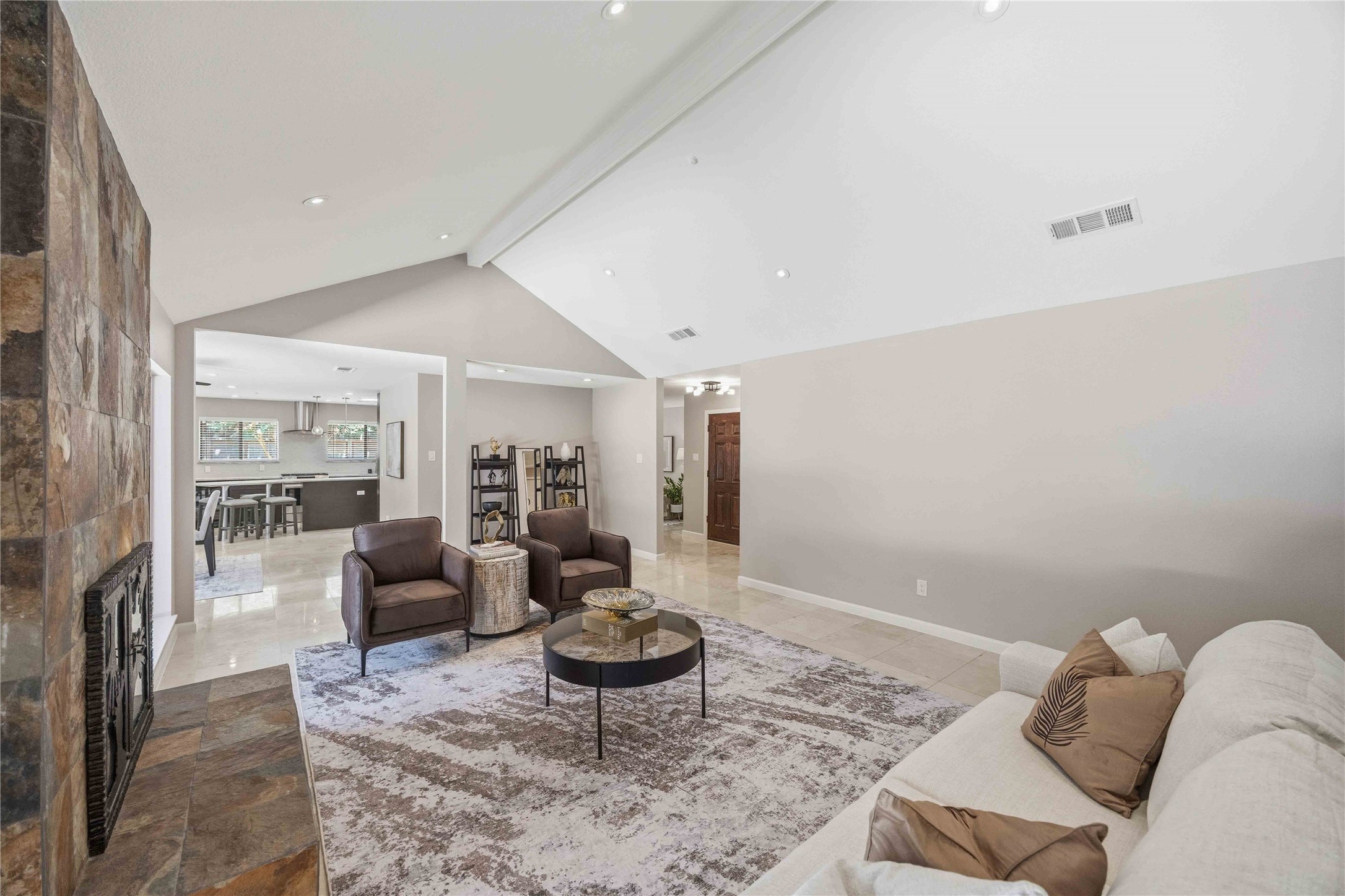 619 Rancho Bauer Drive Houston, TX 77079 - Photo 10 of 46 An inviting first impression begins with soaring vaulted ceilings, expansive windows framing sparkling pool views, and a dramatic floor-to-ceiling stone fireplace that instantly makes you feel at home.