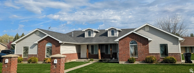 619 East 1st S Street, Unit S Preston, ID 83263 - Photo 14 of 16 Brick and siding exterior featuring multiple dormer windows and an arched entryway