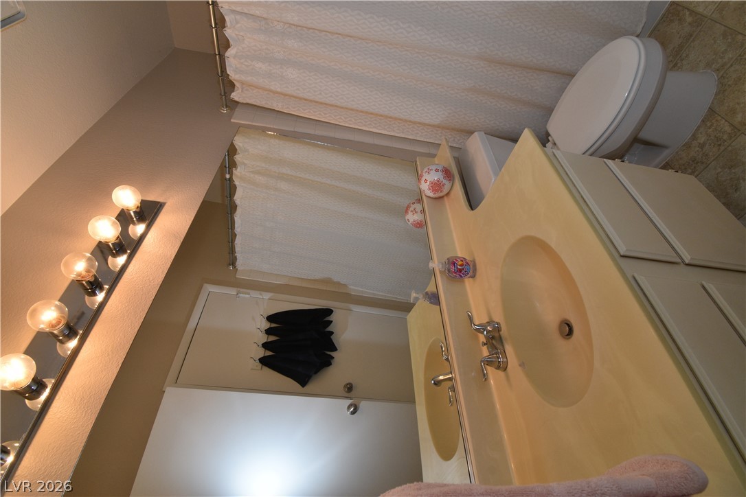 267 Westwind Road Henderson, NV 89074 - Photo 22 of 27 A well-lit vanity with ample mirror space complements the nearby tub/shower combination.