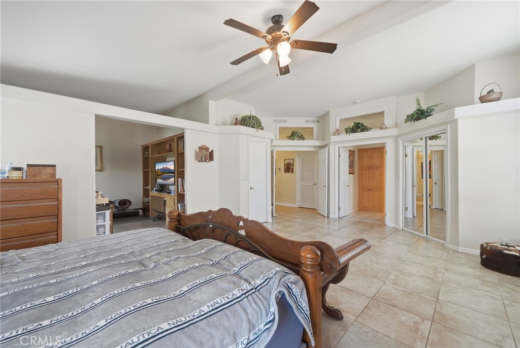 35780 Greer Road Murrieta, CA 92562 - Photo 29 of 56 Primary bedroom w mirrored sliding doors at one closet to right and walk in closet thru door at left. Office space or retreat of 4th bedroom to the left.