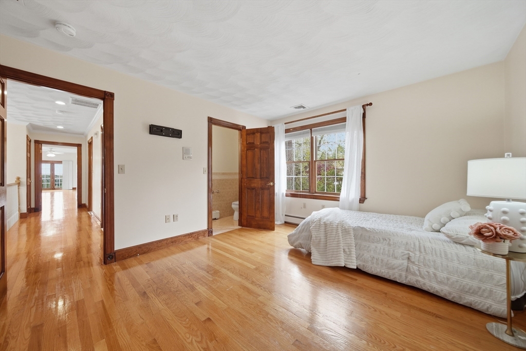 131 Range Heights Road Lynn, MA 01904 - Photo 13 of 36 a bedroom with a bed and wooden floor