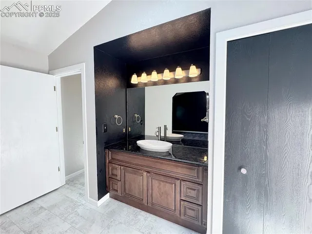 a bathroom with a double vanity sink and a mirror