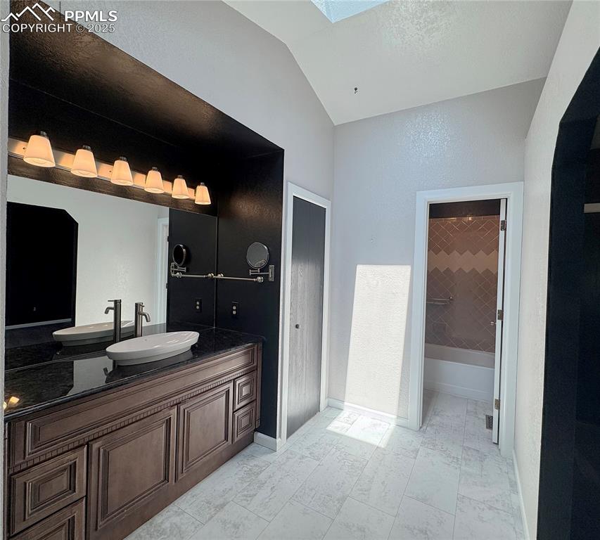 5117 Solar Ridge Drive Colorado Springs, CO 80917 - Photo 12 of 28 a bathroom with a double vanity sink and a mirror
