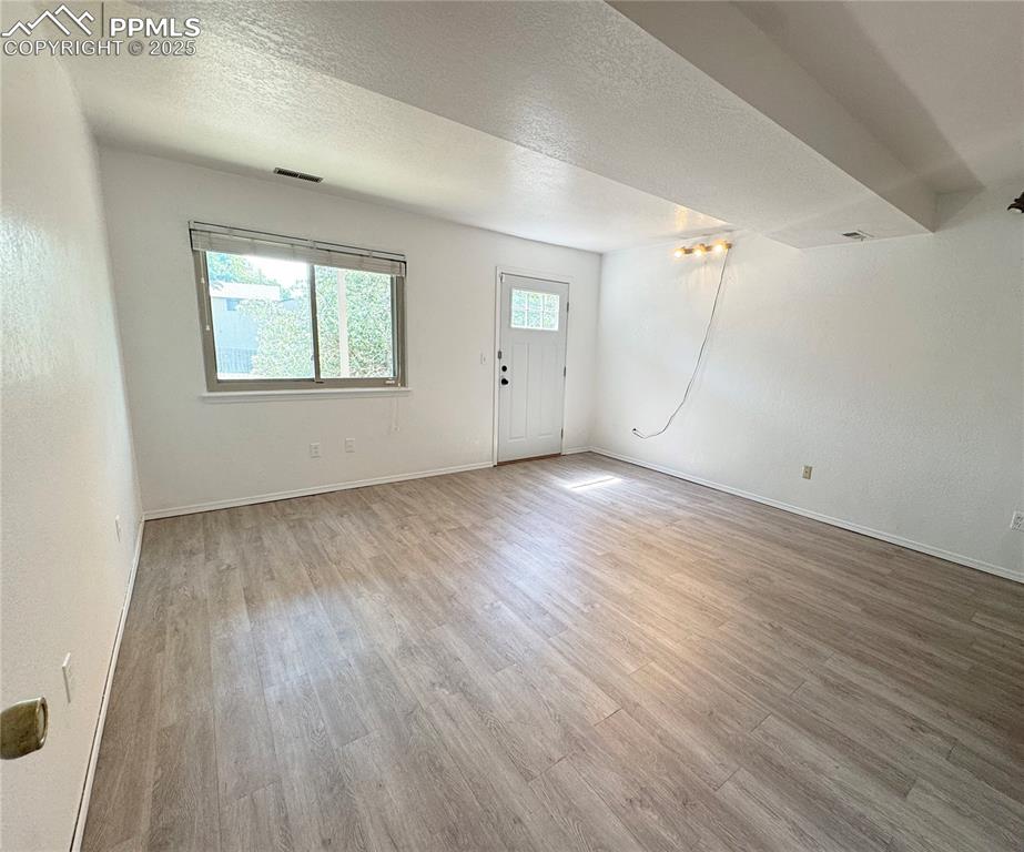 5117 Solar Ridge Drive Colorado Springs, CO 80917 - Photo 23 of 28 an empty room with wooden floor and windows