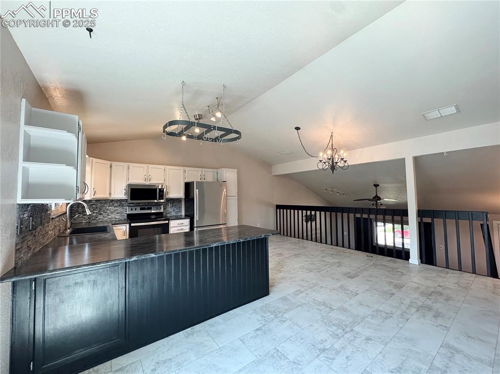 5117 Solar Ridge Drive Colorado Springs, CO 80917 - Photo 6 of 28 a kitchen with kitchen island granite countertop a stove and a sink with cabinets