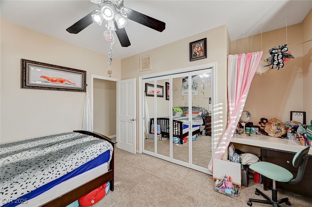 2125 Mateuse Street Logandale, NV 89021 - Photo 43 of 62 Bedroom with a closet, a ceiling fan, and carpet