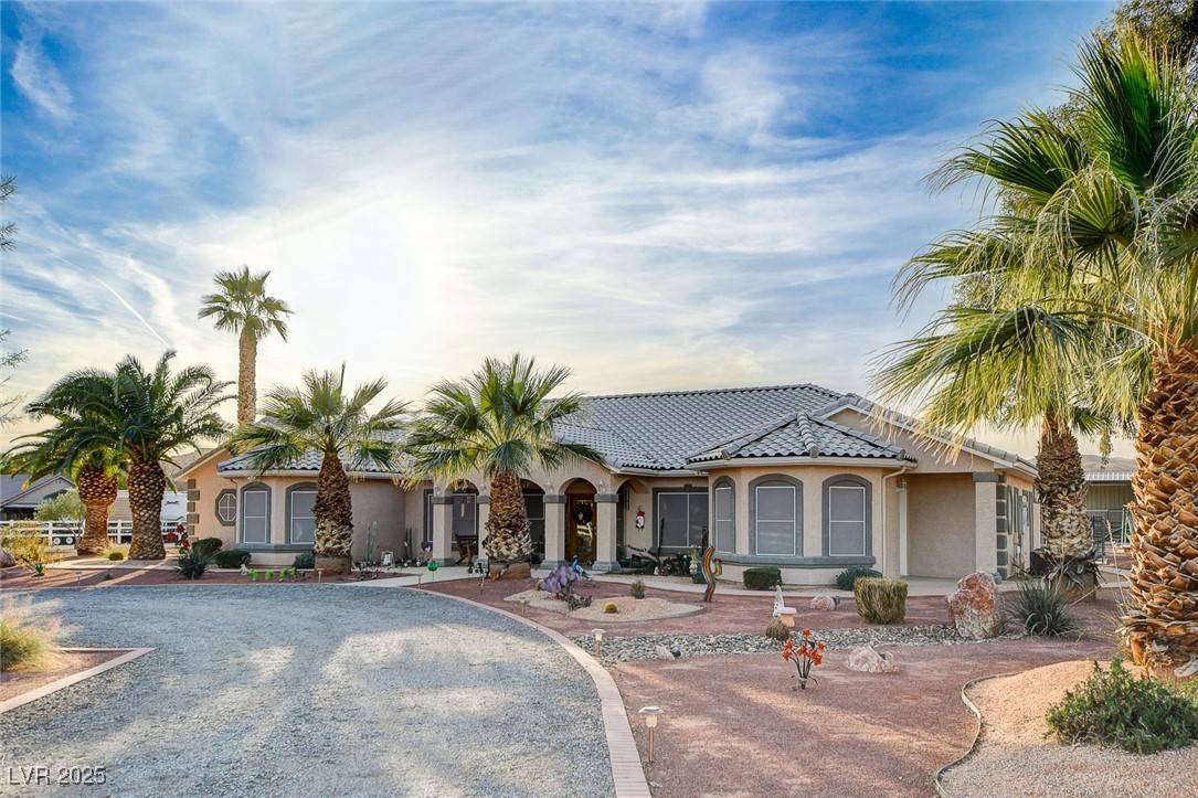 2125 Mateuse Street Logandale, NV 89021 - Photo 61 of 62 View of front of house featuring gravel driveway, a tiled roof, and stucco siding