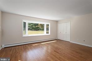 16 Cherry Brook Drive Princeton, NJ 08540 - Photo 15 of 28 an empty room with wooden floor and windows