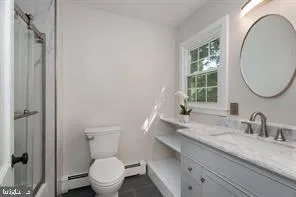 a bathroom with a granite countertop sink toilet and a mirror
