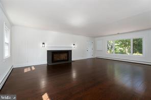 16 Cherry Brook Drive Princeton, NJ 08540 - Photo 5 of 28 an empty room with wooden floor and a fireplace