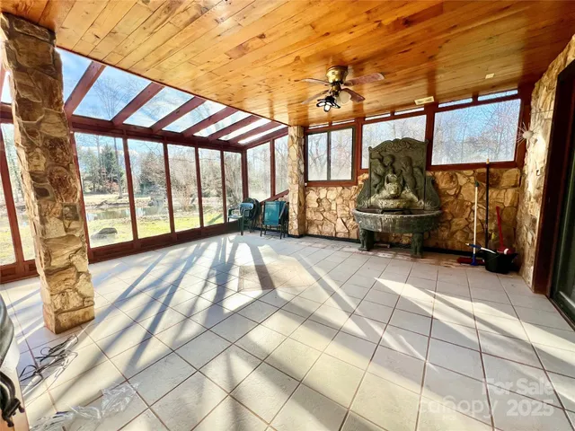 a view of a hallway with wooden floor and entryway
