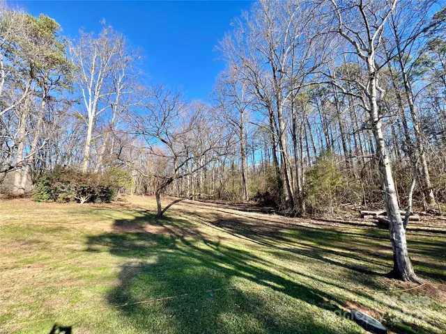a view of a tennis ground with trees