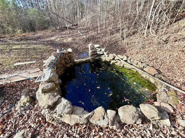 a view of white house with a yard covered in the snow