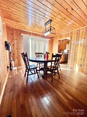 a dining room with furniture and wooden floor