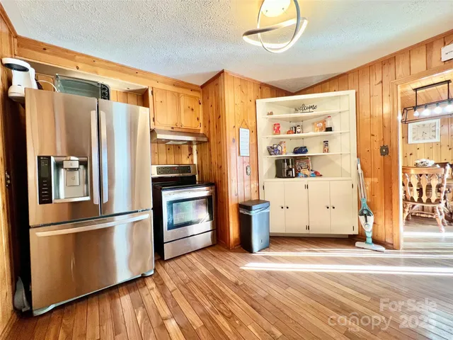 a kitchen with stainless steel appliances a refrigerator and a stove top oven