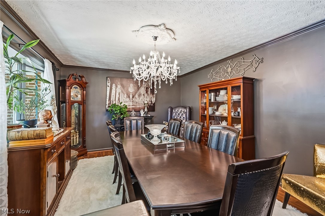 6890 Refugee Road Pickerington, OH 43147 - Photo 7 of 49 Formal dining area featuring a crystal chandelier and decorative ceiling medallion