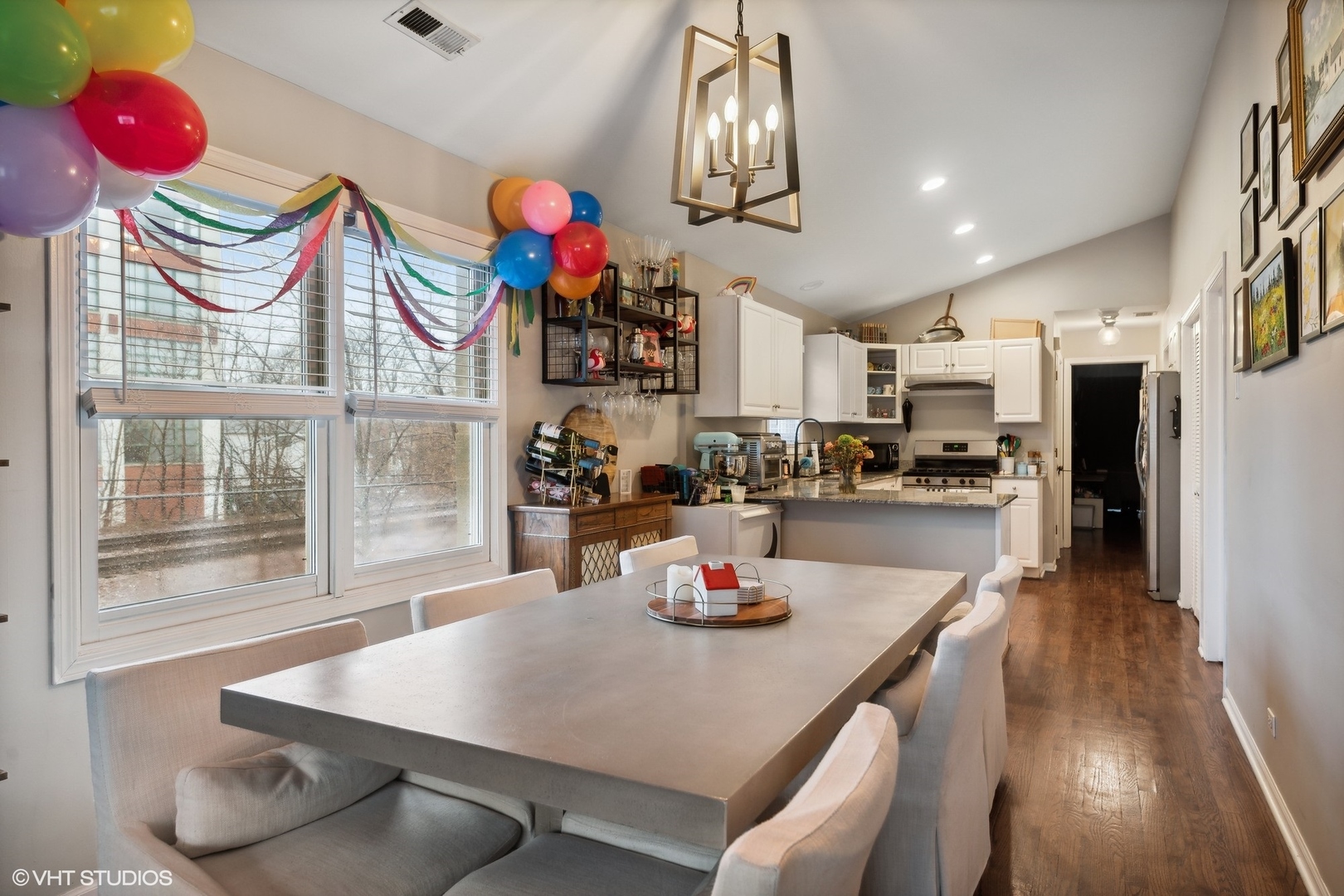 1756 West Roscoe Street Chicago, IL 60657 - Photo 12 of 19 a kitchen with stainless steel appliances granite countertop a sink dishwasher and a dining table with wooden floor