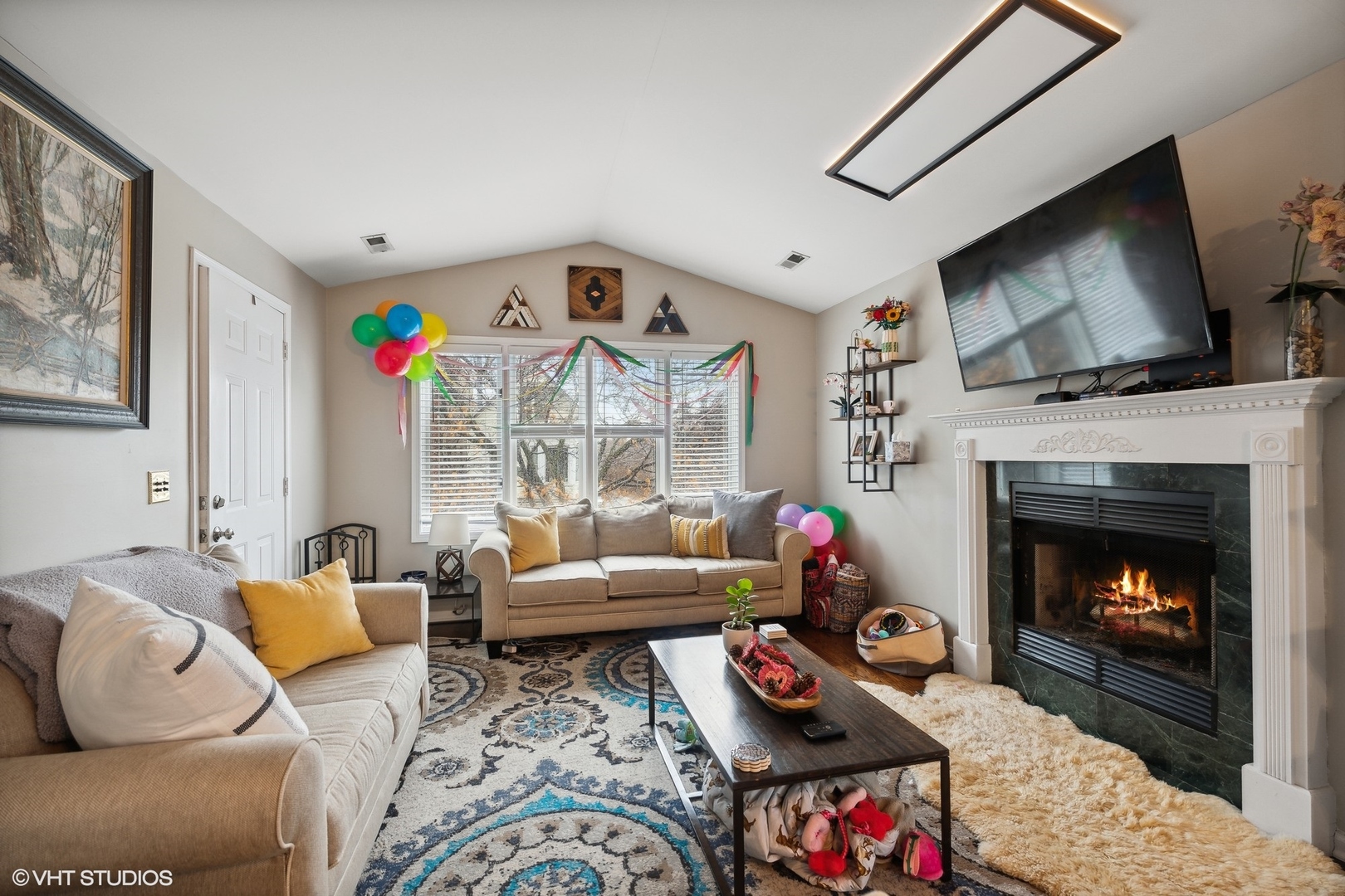 1756 West Roscoe Street Chicago, IL 60657 - Photo 13 of 19 a living room with furniture a flat screen tv and a fireplace