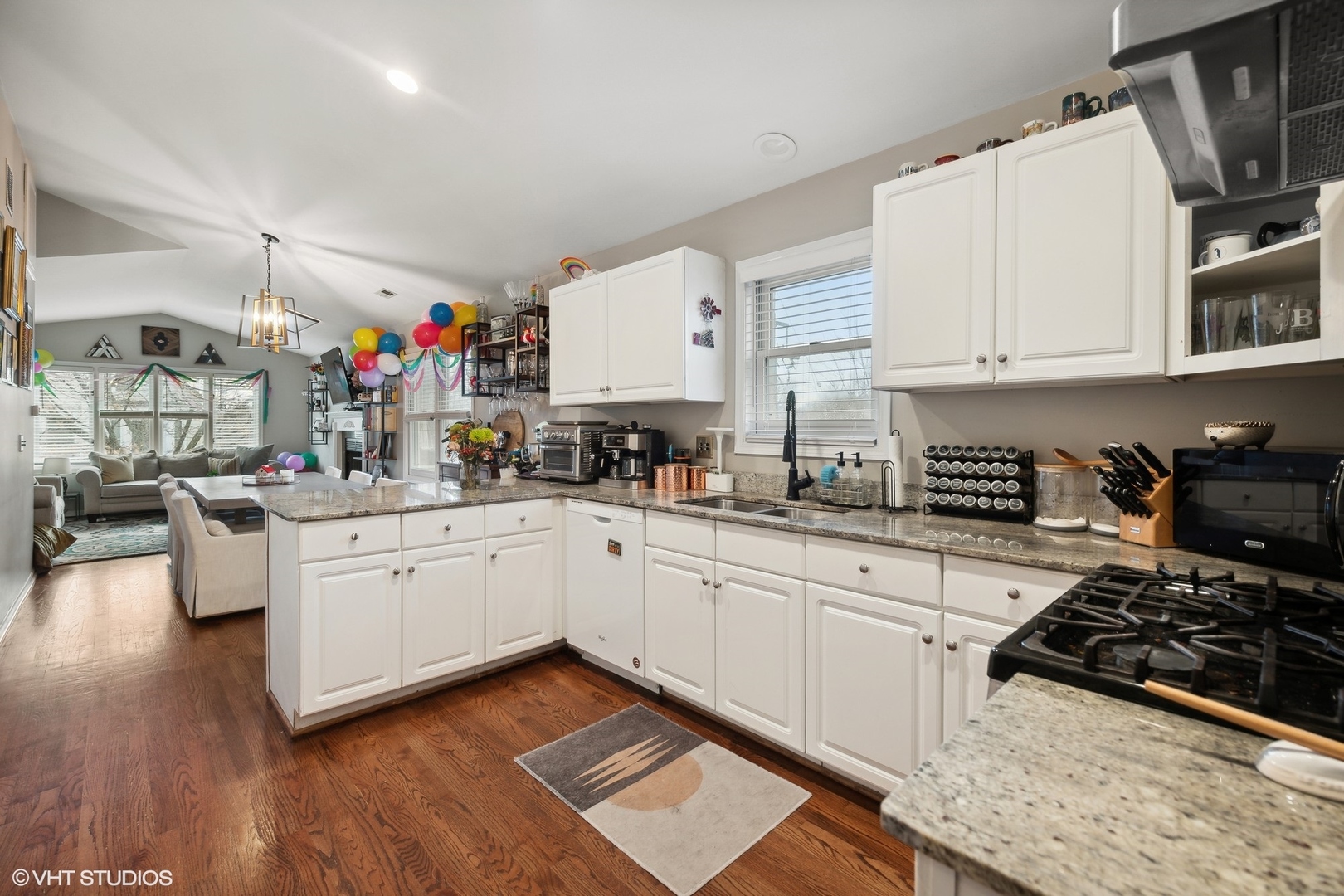 1756 West Roscoe Street Chicago, IL 60657 - Photo 15 of 19 a kitchen with granite countertop a sink stove and cabinets