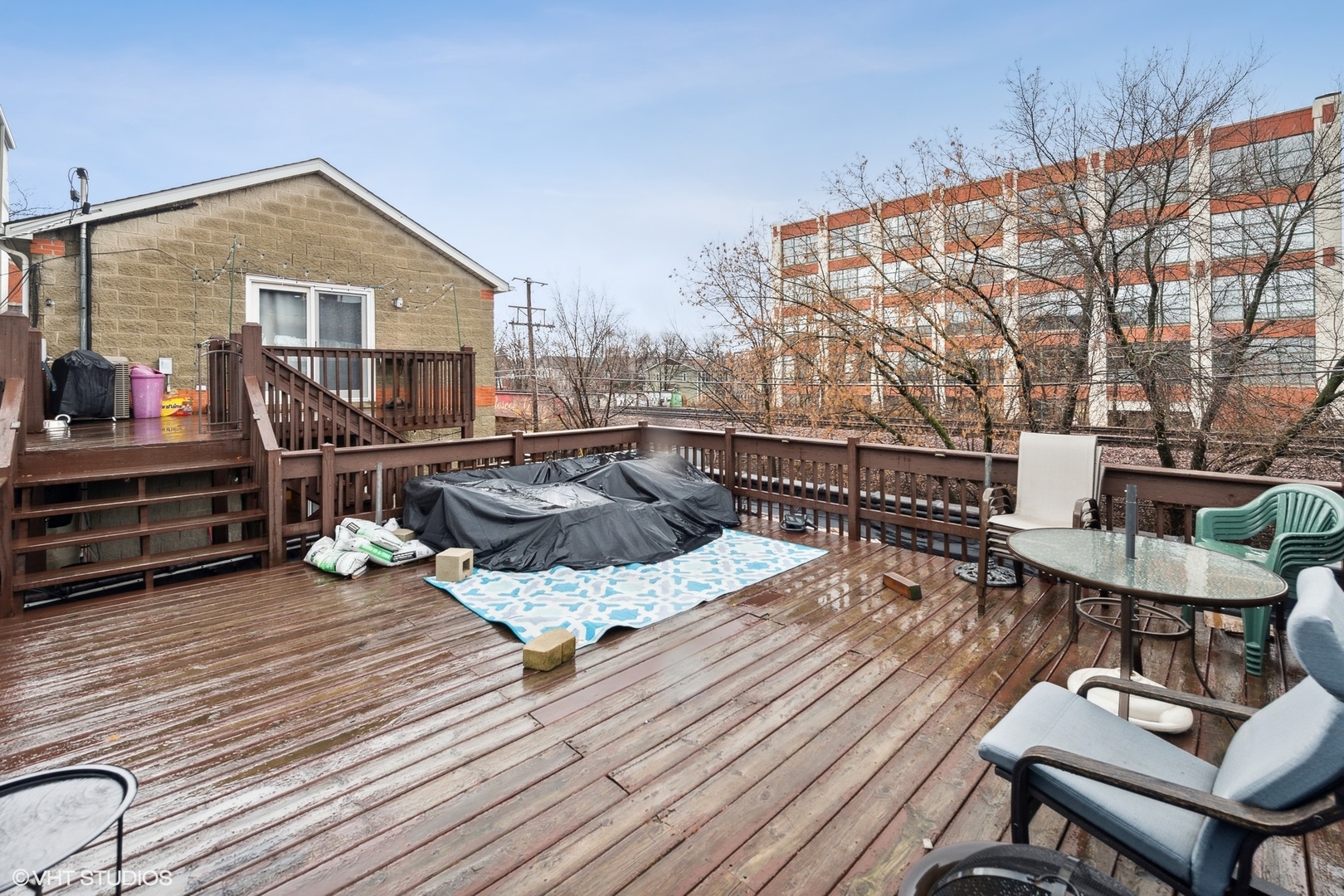 1756 West Roscoe Street Chicago, IL 60657 - Photo 16 of 19 a roof deck with table and chairs and wooden floor