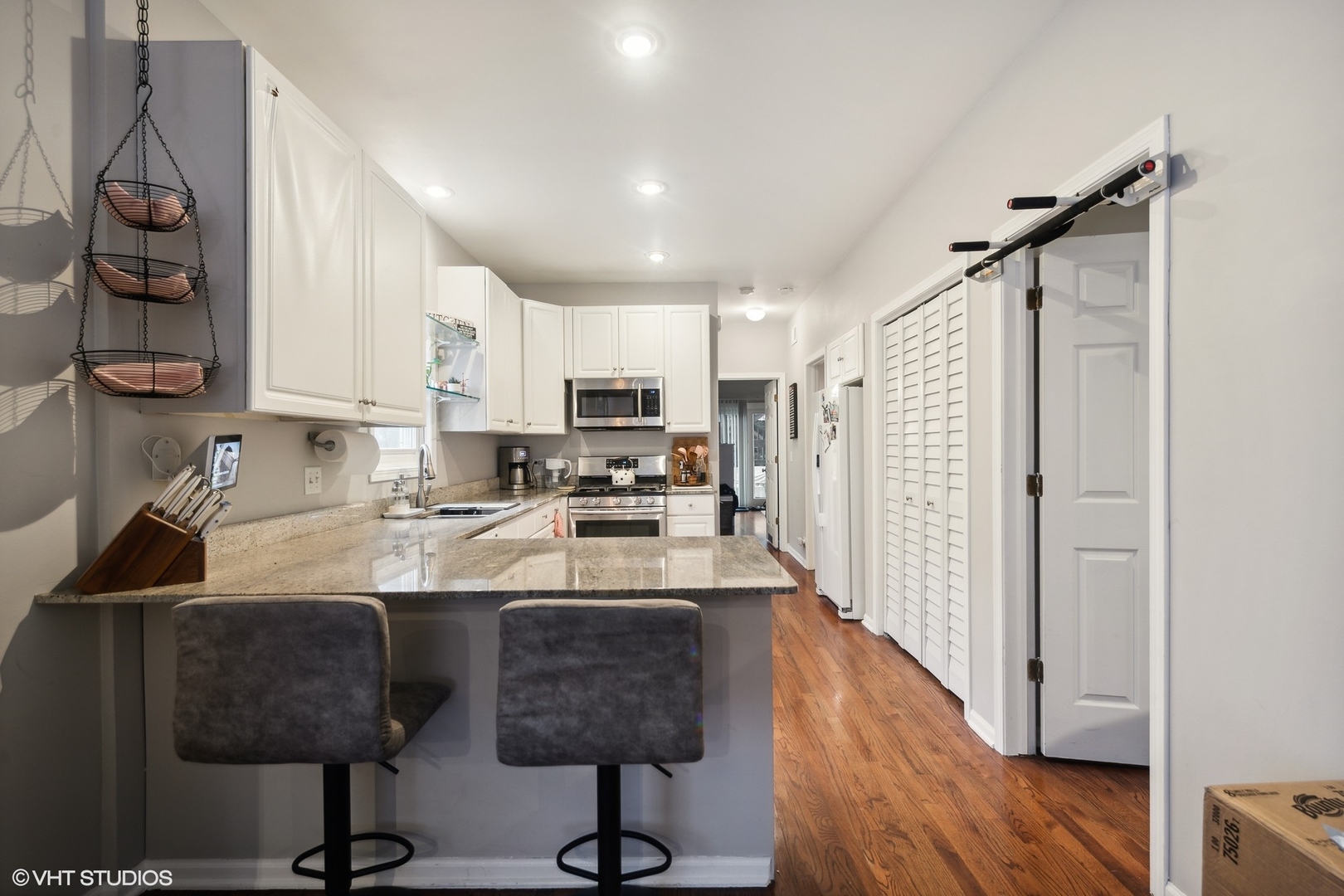 1756 West Roscoe Street Chicago, IL 60657 - Photo 5 of 19 a kitchen with stainless steel appliances granite countertop a sink refrigerator and cabinets