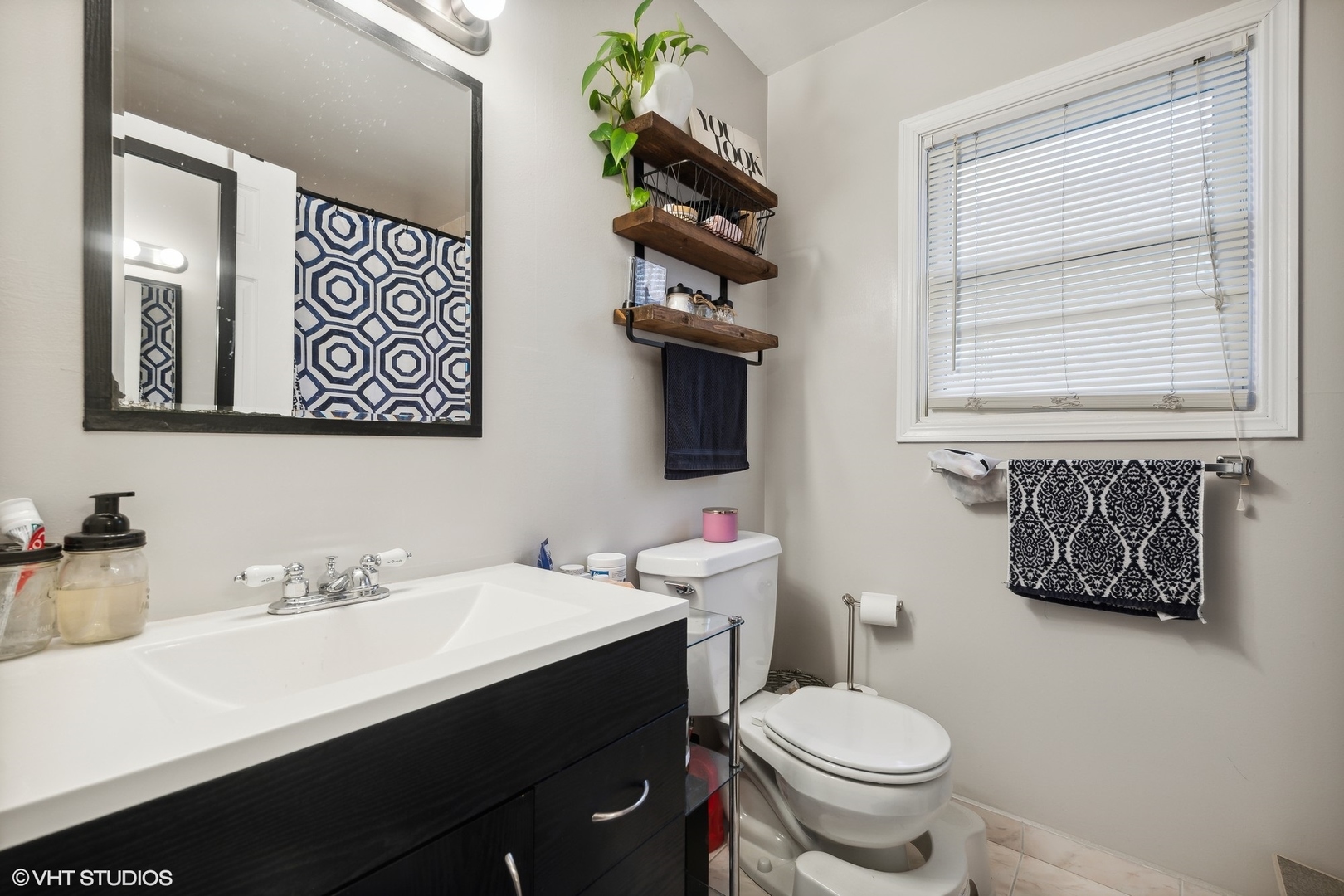 1756 West Roscoe Street Chicago, IL 60657 - Photo 7 of 19 a bathroom with a toilet sink and mirror