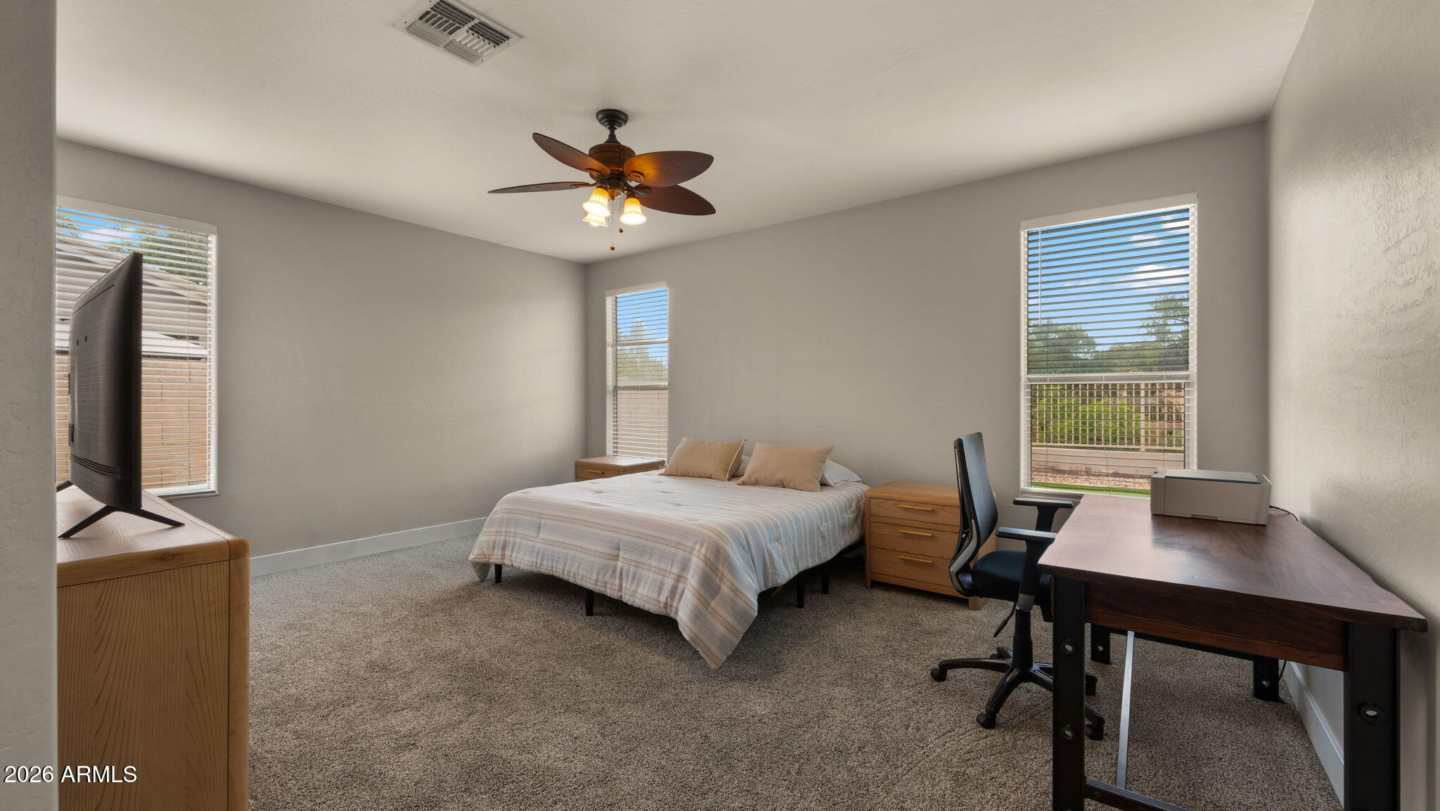 3344 East Hopkins Road Gilbert, AZ 85295 - Photo 13 of 32 a bedroom with a bed and a desk