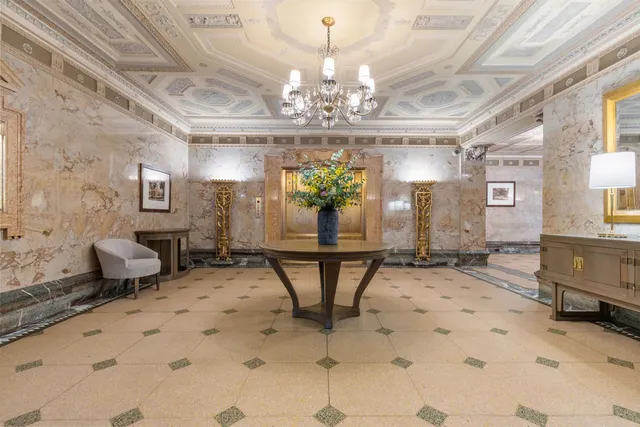 a view of a dining room with furniture and a chandelier