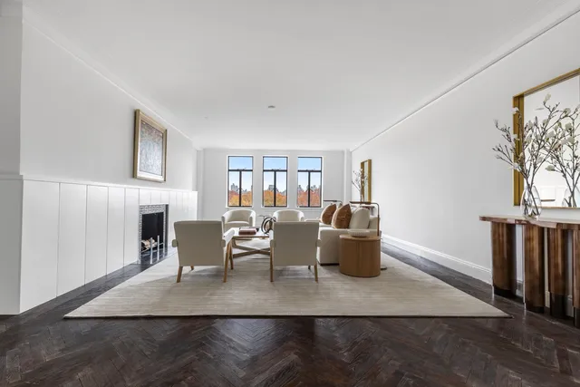 a living room with furniture wooden floor and a fireplace