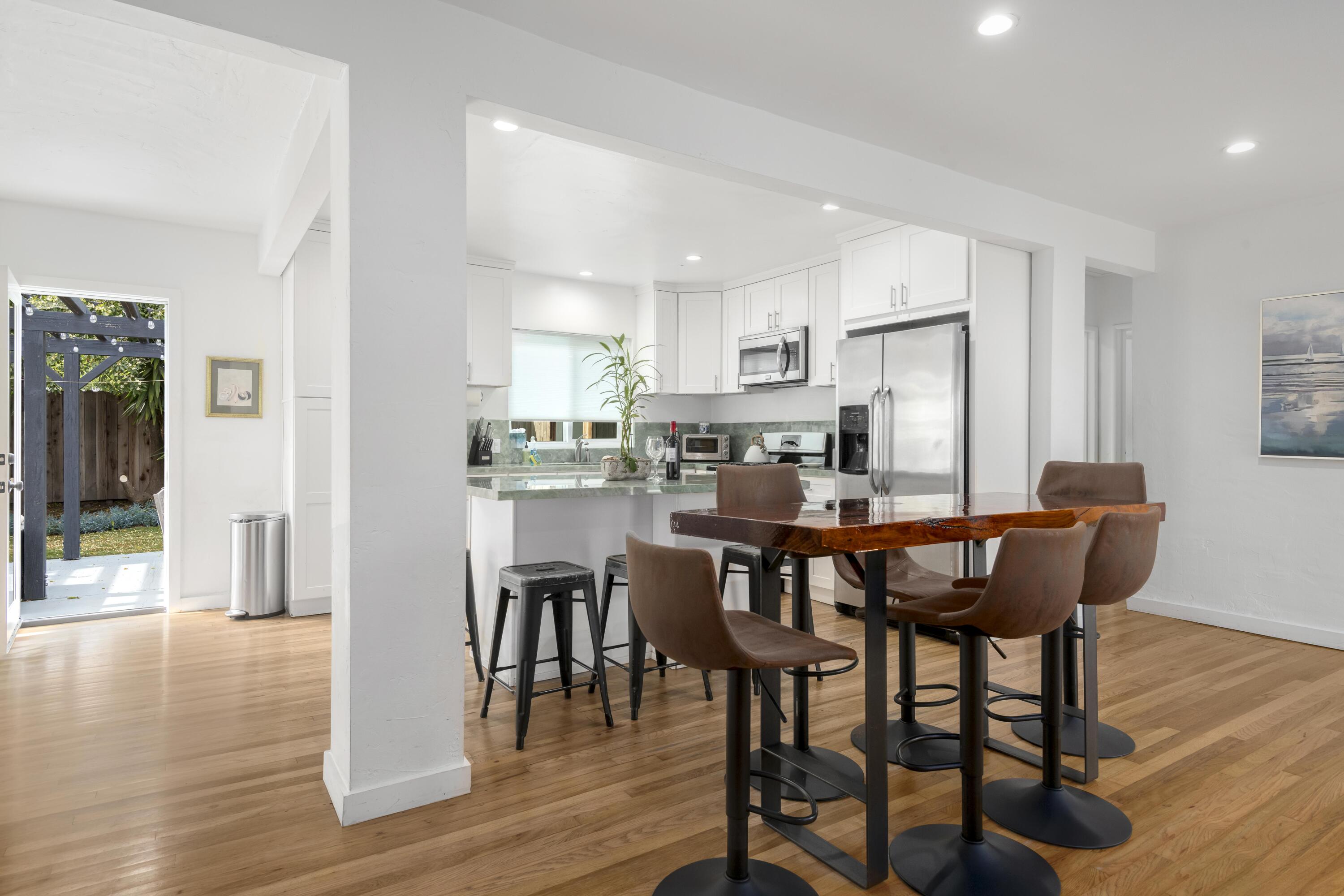 1102 Del Mar Avenue Santa Barbara, CA 93109 - Photo 12 of 39 a kitchen with a dining table chairs and refrigerator