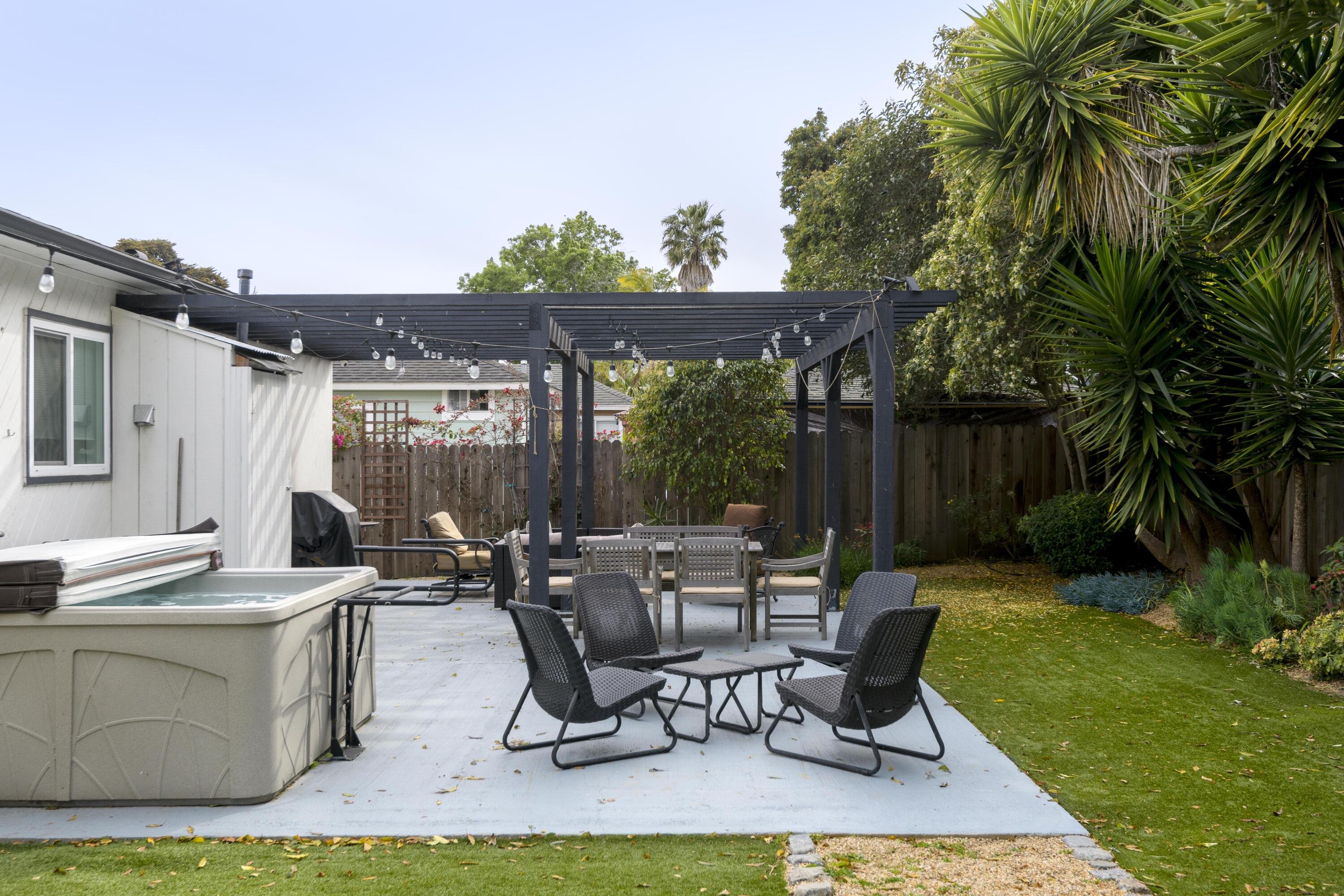 1102 Del Mar Avenue Santa Barbara, CA 93109 - Photo 23 of 39 a view of a patio with table and chairs potted plants and palm tree