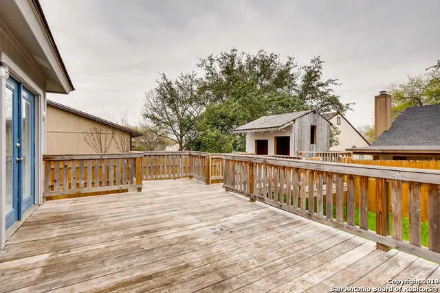 a view of a house with wooden deck