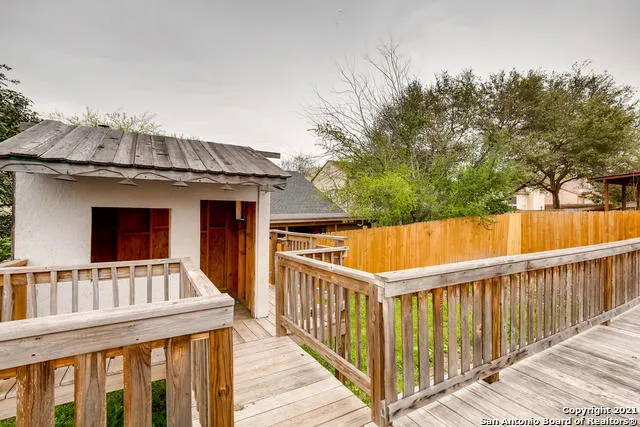 a view of a house with wooden fence