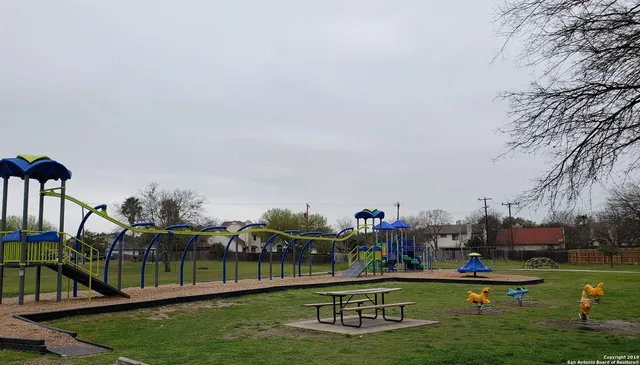 a view of a swimming pool with a yard and a fountain