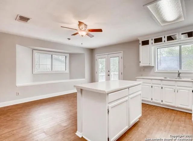a kitchen with a sink cabinets and window