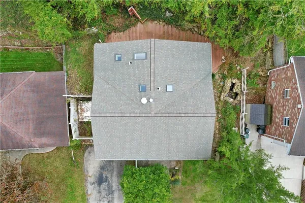 an aerial view of a house with a garden and a yard