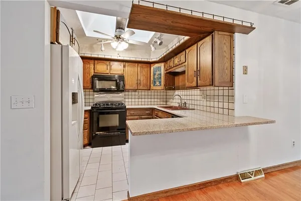 a kitchen that has a sink and a stove top oven
