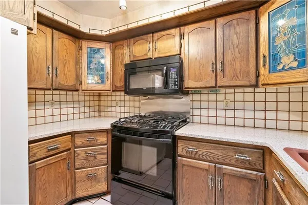 a kitchen with granite countertop a stove top oven