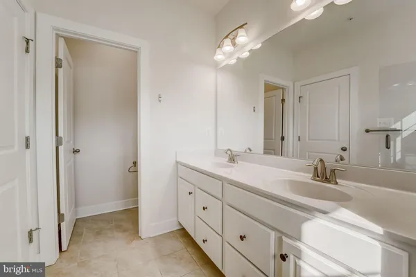 a bathroom with a double vanity sink and a mirror