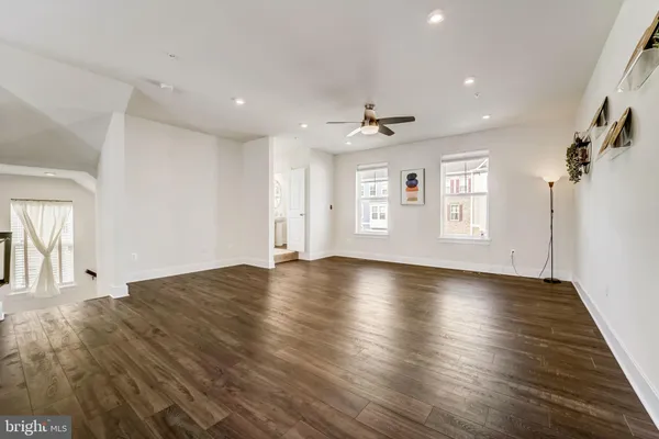 a view of a livingroom with wooden floor and window