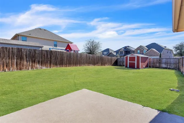 a view of a house with a big yard and large trees