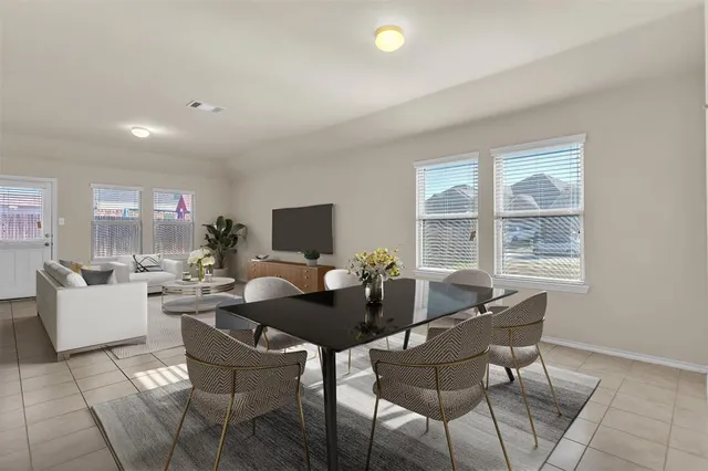 a dining room with a table and chairs